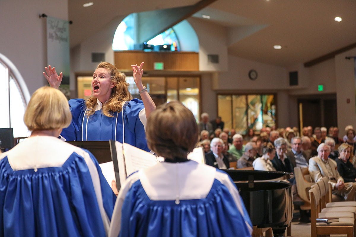 Christie directing the choir during worship